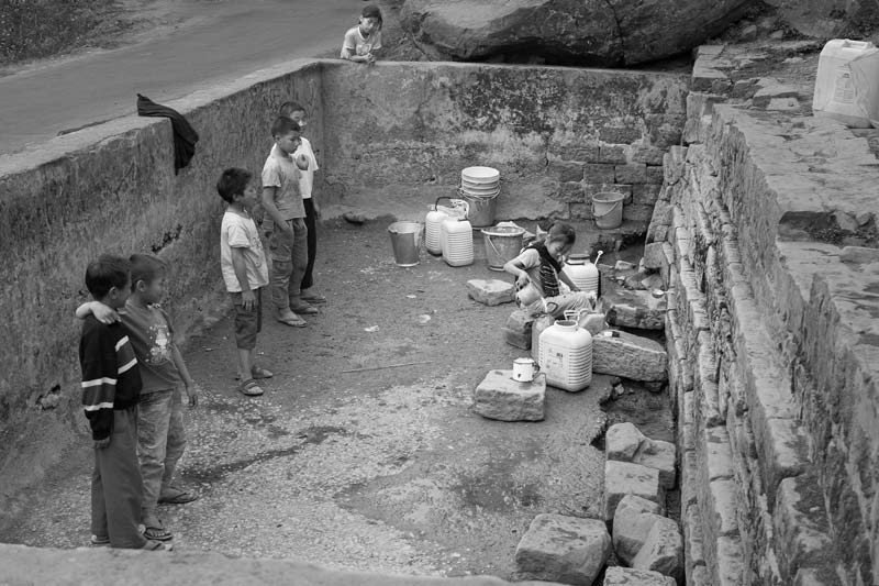 Scooping out water during the lean season from a dried up spring-fed tank in Mokokchung district, Nagaland